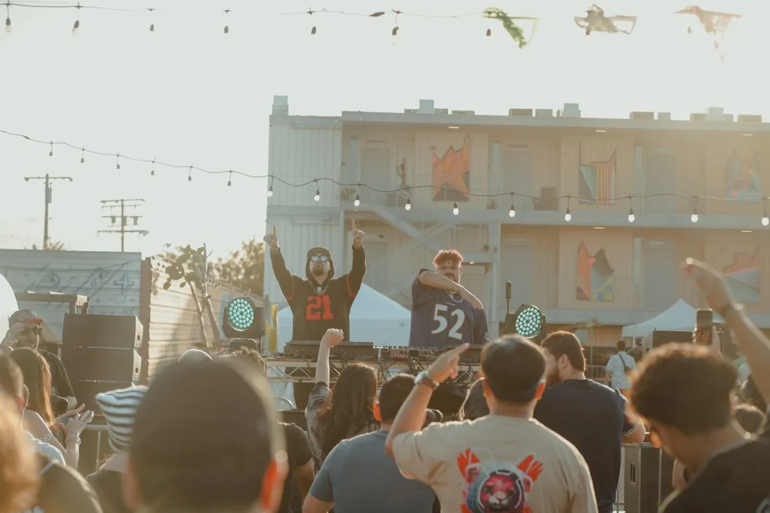 Crowd with hands up in front of the day stage