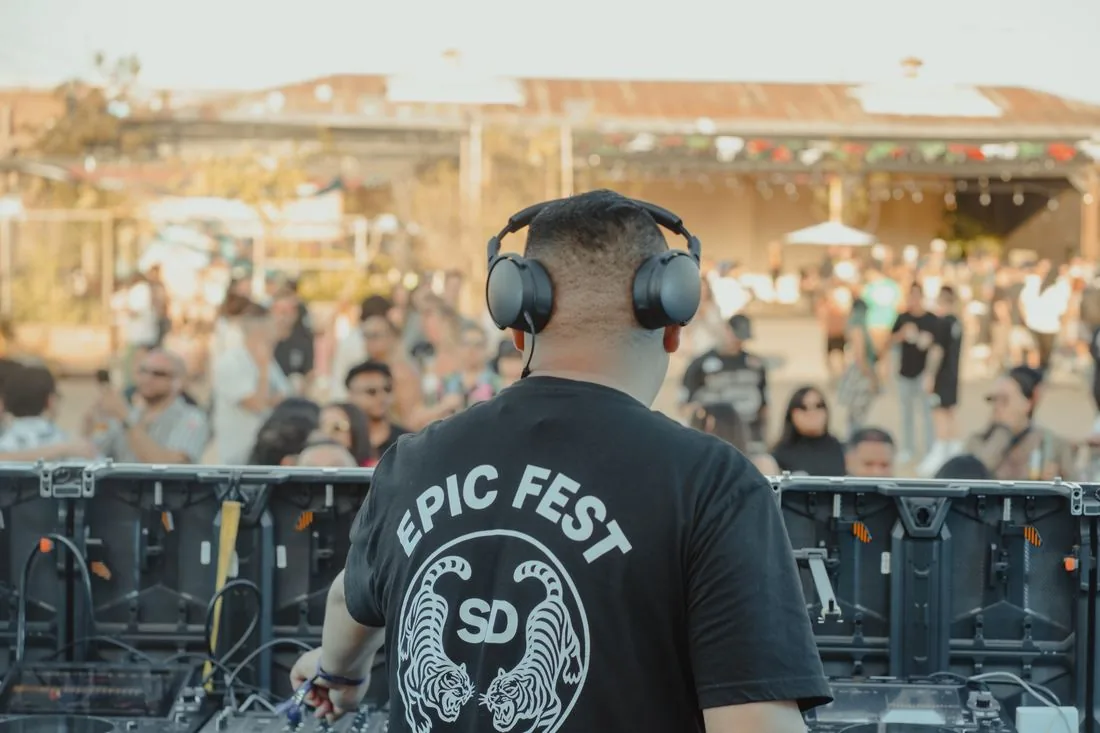 Person in an EPIC Fest SD shirt at the decks with the crowd behind