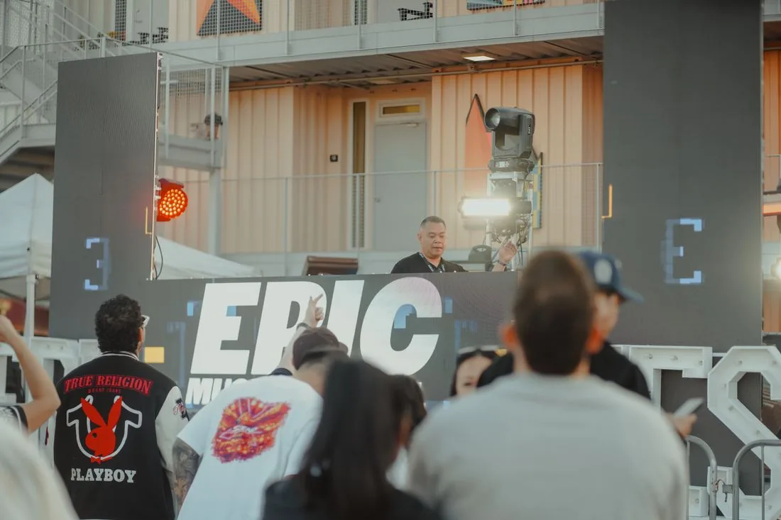 Speaker stacks beside the EPIC letters on the stage wall