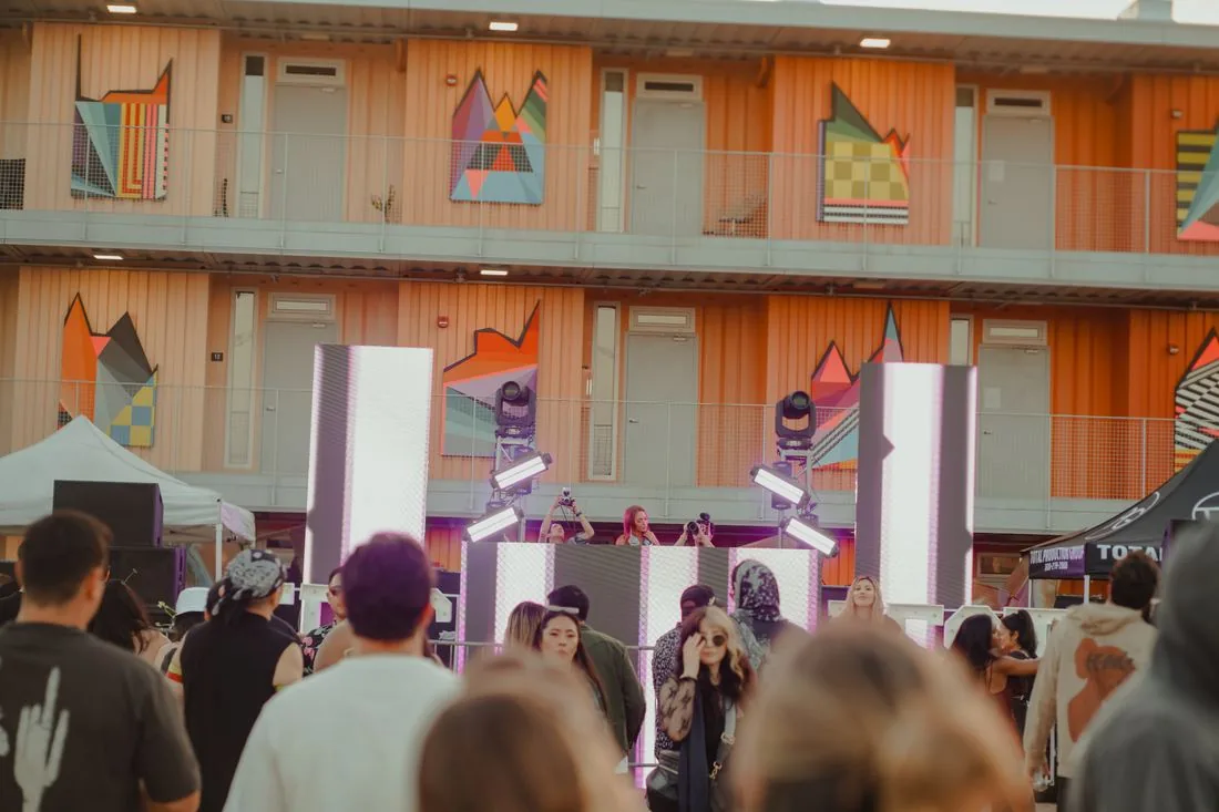 Crowd in front of the painted warehouse wall