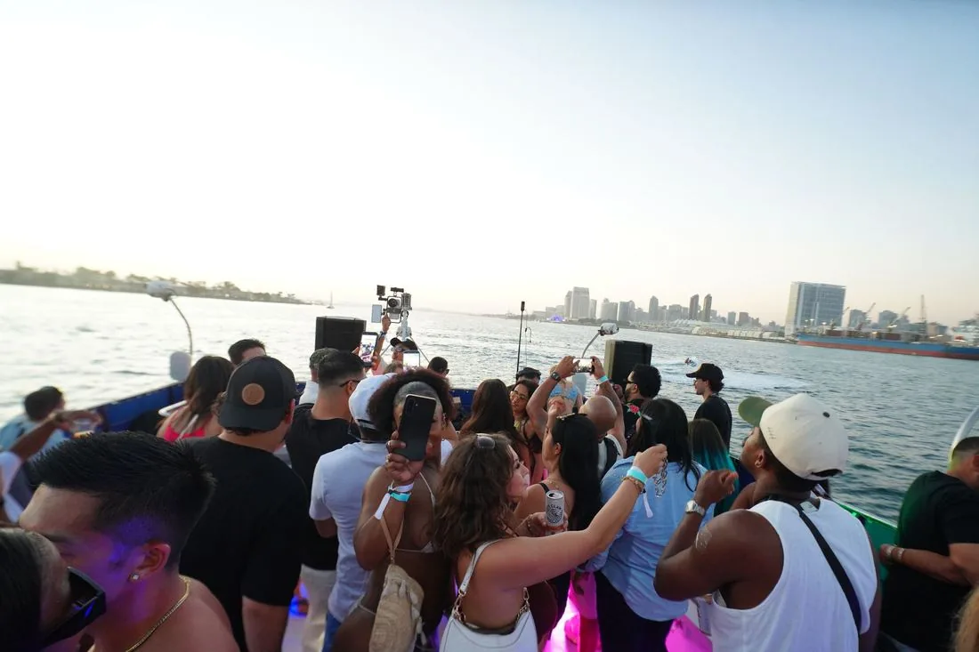 Crowd at the rail with the San Diego skyline behind at dusk